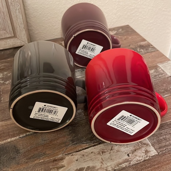 3 Le Creuset coffee mugs purple, grey, red new with tags. Has some small marks. - Picture 3 of 5
